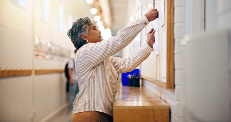 Bulletin board, announcement or woman in school hallway, motivation or sign up for school program. Promotion, details or mature teacher with notice, information or location to encourage participation
